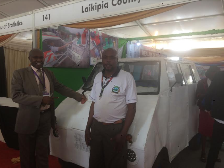 Dr Kamau at DevCon2019, next to the Laikipia County Vehicle Innovation Stand