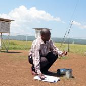 Adegu David, District Meteorological Officer shows the scientific processes of gathering and monitoring data